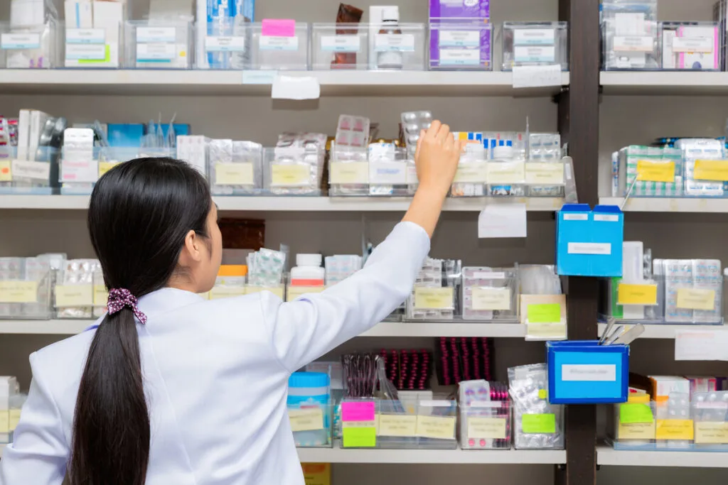 Taking medication from pharmacy shelf for Thailand packing list