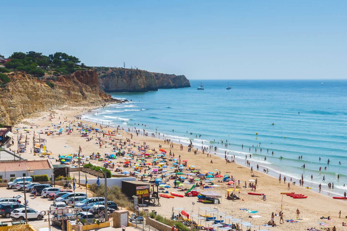 Many tourists on Porto de Mos Beach in Lagos in the Algarve, Portugal.