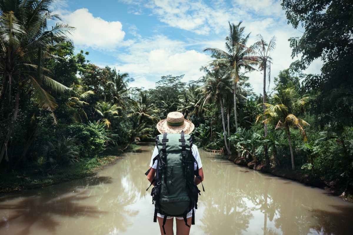 Hiker at lagoon best travel backpacks for women