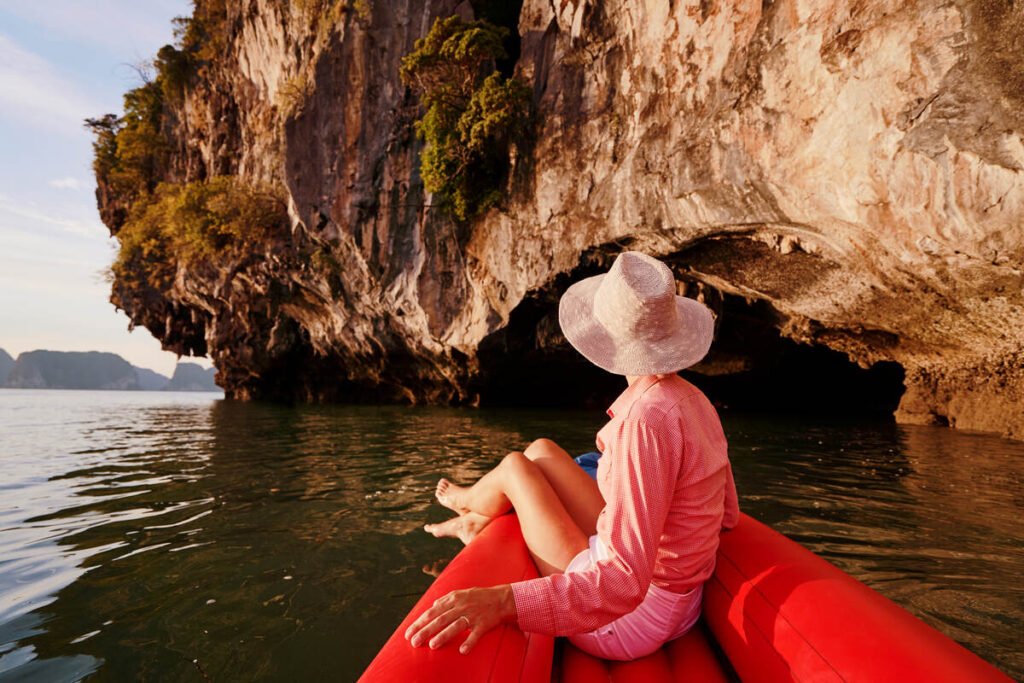 Woman in sea kayak besides Koh Hong Island on a Krabi island tour.
