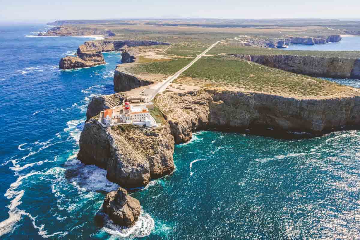 Aerial view of the cliff edge with lighthouse at Sagres Region in Algarve.