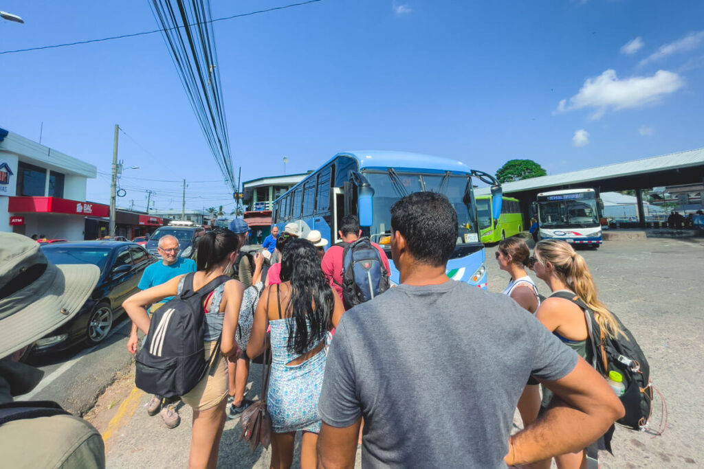 People standing in line to board the shuttle bus.