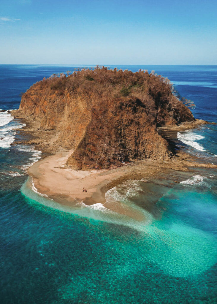 An aerial shot of Isla Chora and it's beautiful blue waters.