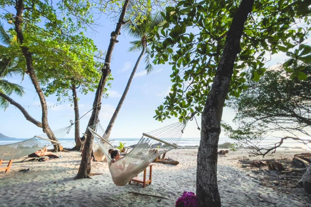 Relaxing in a hammock at Tropico Latino Bar can help destress while backpacking in Costa Rica.