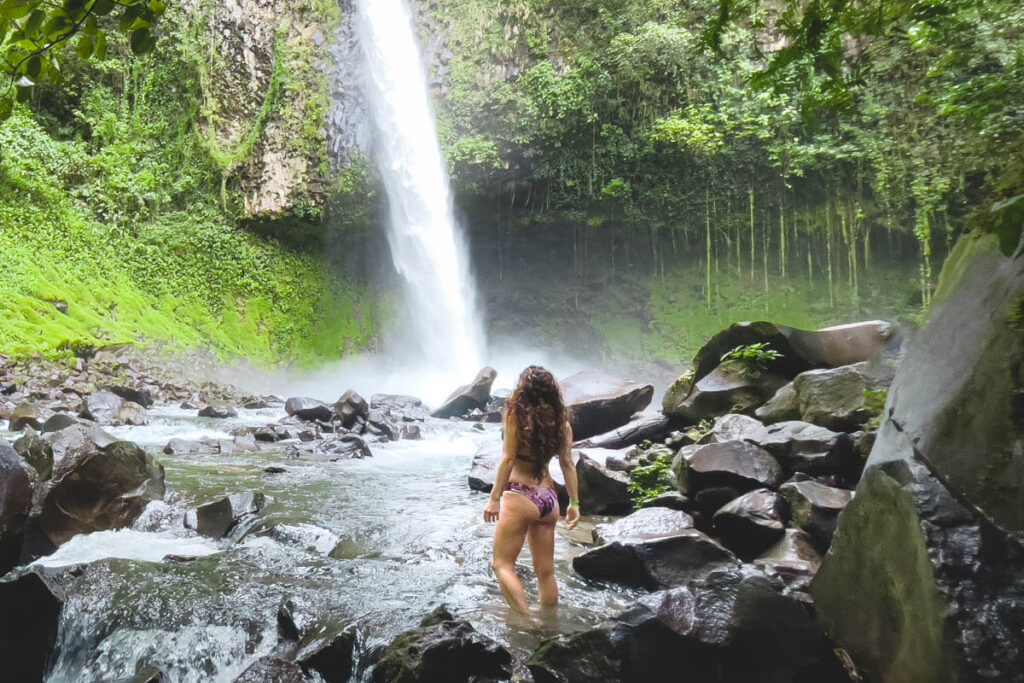 Women standing at the bottom of La Fortuna waterfall.