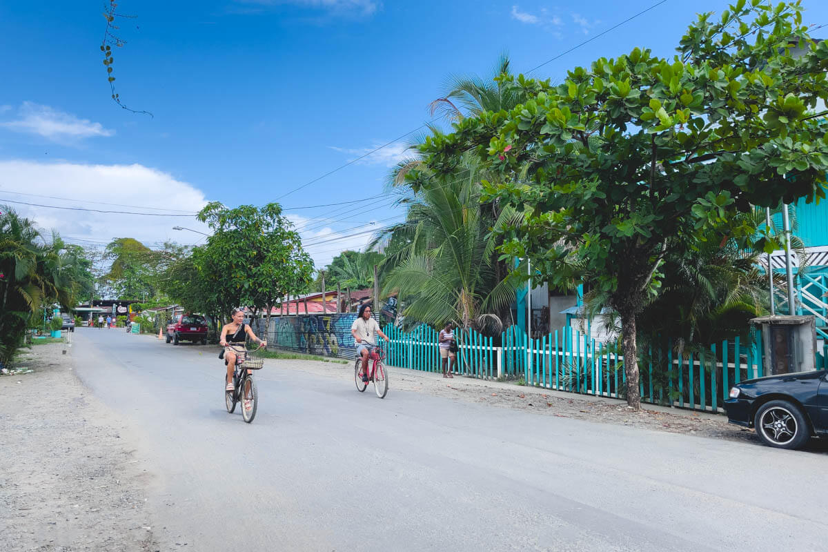 Two cyclists riding down one of the main roads in Puerto Viejo. Two cyclists riding down one of the main roads in Puerto Viejo.