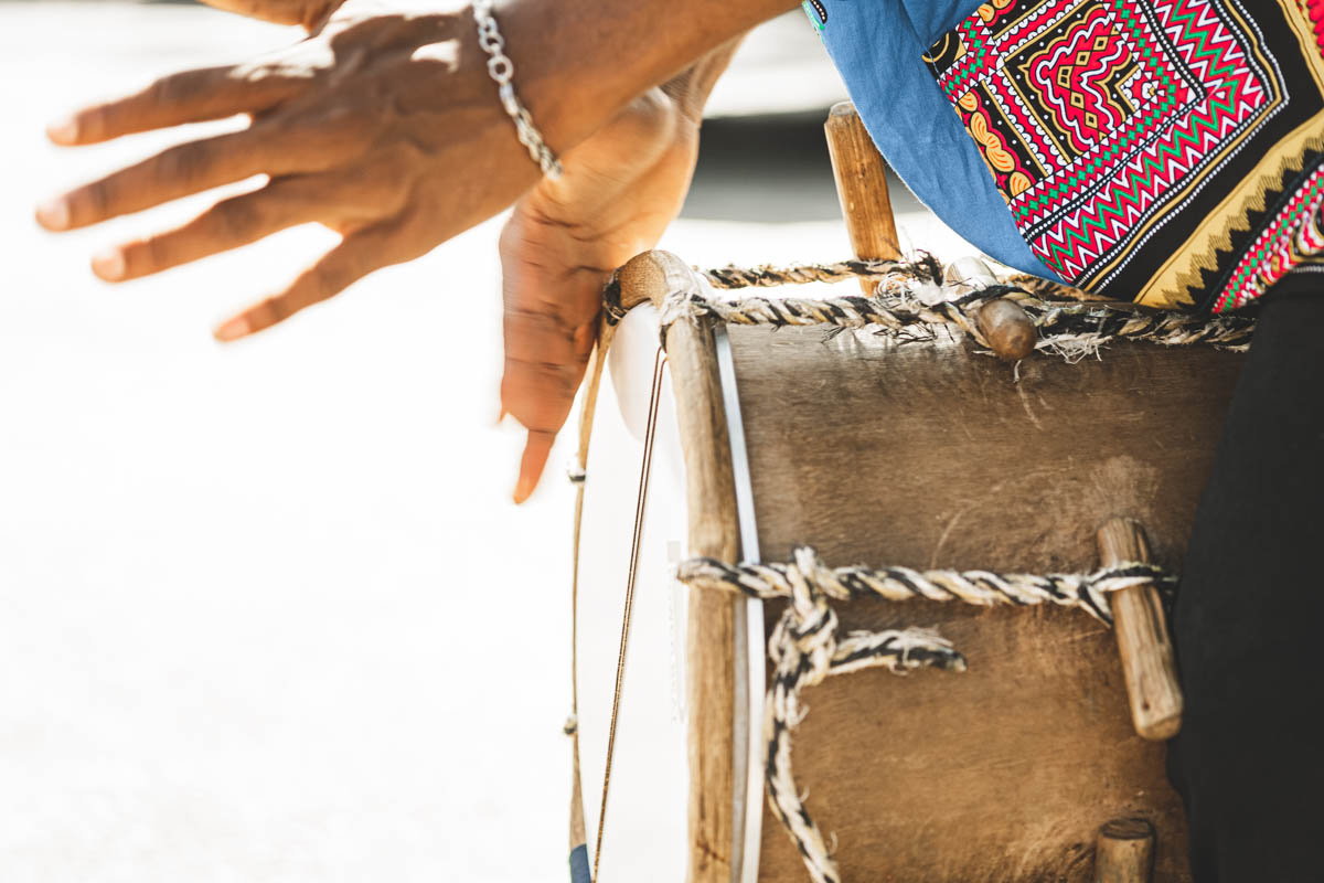 A person playing a traditional instrument of the Garifuna culture.
