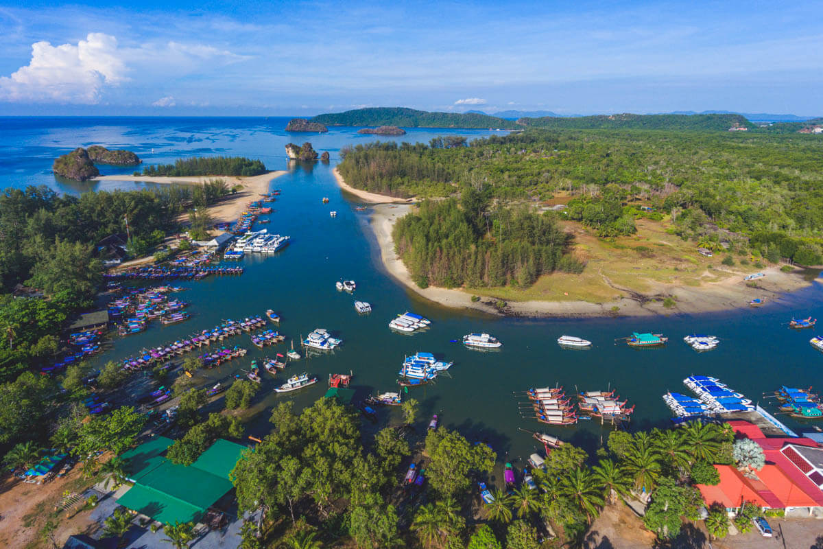 Aerial view of a river winding all the way to the ocean and the white sands of Nopparat Thara Beach - one of the best Krabi Beaches. Aerial view of a river winding all the way to the ocean and the white sands of Nopparat Thara Beach - one of the best Krabi Beaches.