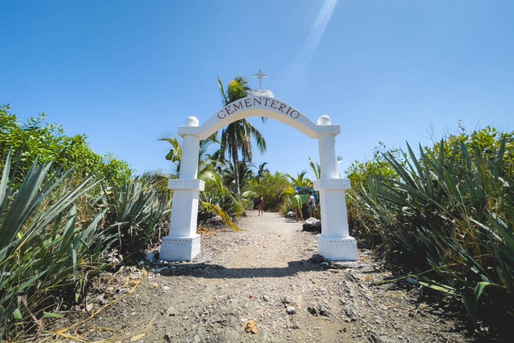 The large white arch that marks the entrance to the Cabuya Island Cemetery near Montezuma.