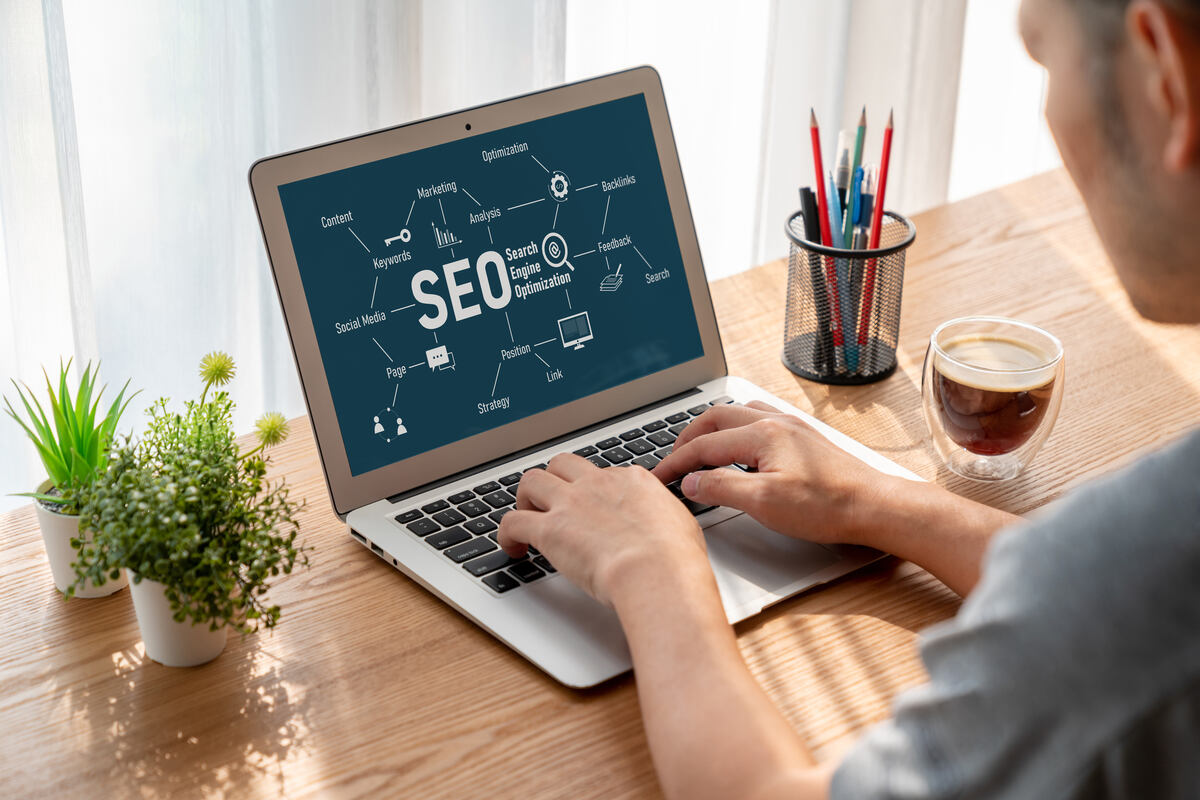 SEO on a computer screen and a digital nomad working