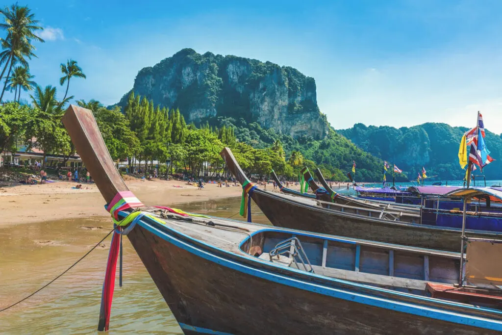 Thai fishing boats lining up along Ao Nang Beach which is one of the main beaches in Krabi, Thailand.