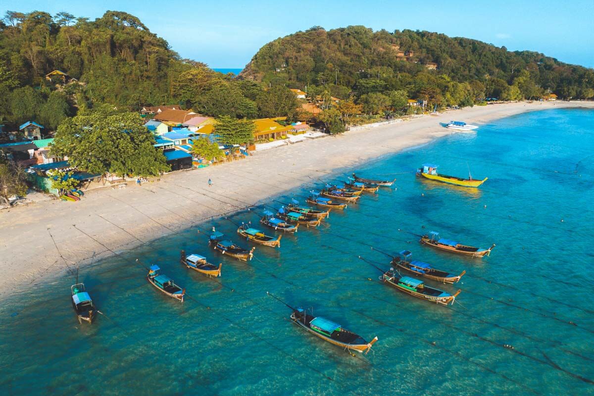 A group of Thai fishing boats moored just off shore of Laem Tong Beach in Koh Phi Phi. A group of Thai fishing boats moored just off shore of Laem Tong Beach in Koh Phi Phi.