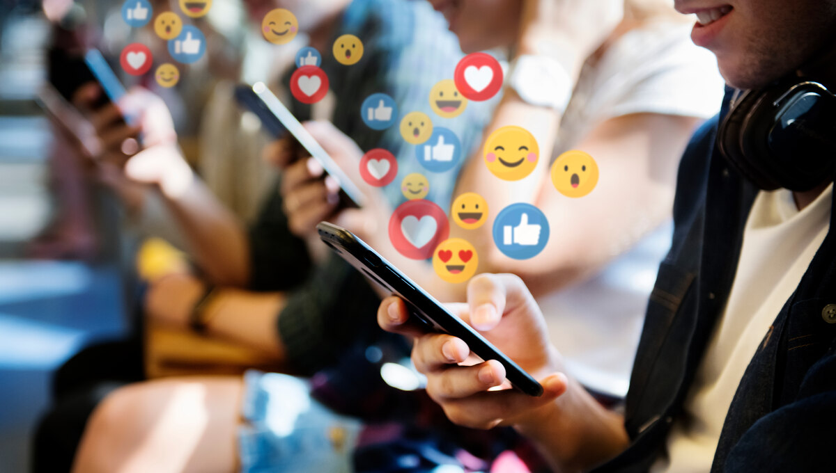 People on the phone with emojis floating