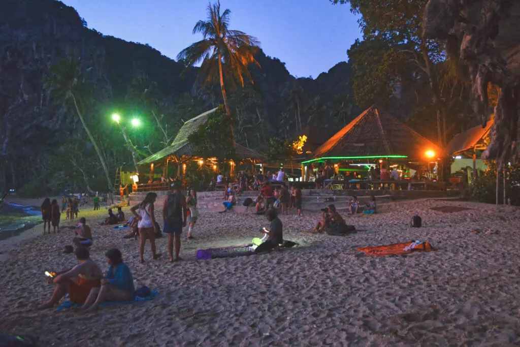 A bunch of tourists sitting on Tonsai Beach in Krabi at night and enjoying the local nightlife.
