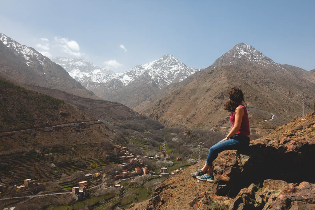 Nina sitting on a rock checking out the Mount Toubkal in Imlil. 