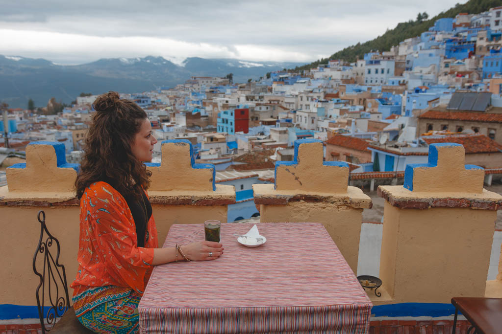 Nina enjoying a traditional mint tea on a rooftop terrace in Chefchaouene Morocco.