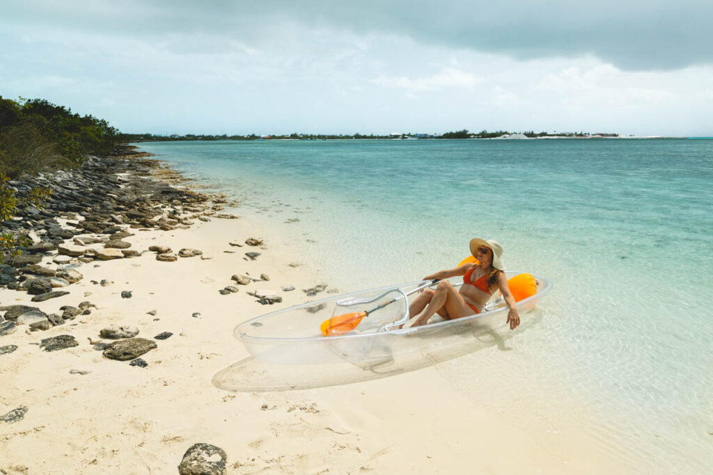 Nina basking in the sun in her clear kayak in the waters of Turks and Caicos.