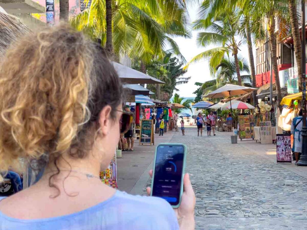 Nina checking Nomad eSIM app on her phone to see data while in Mexico