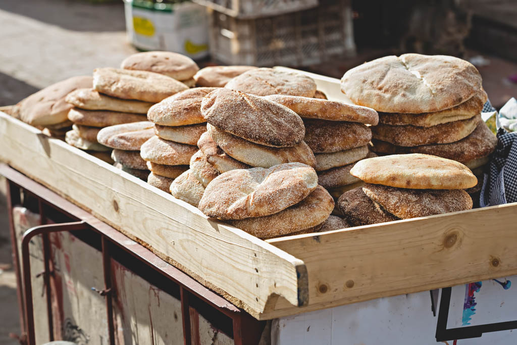 Khobz bread on a wooden street cart in Morocco.