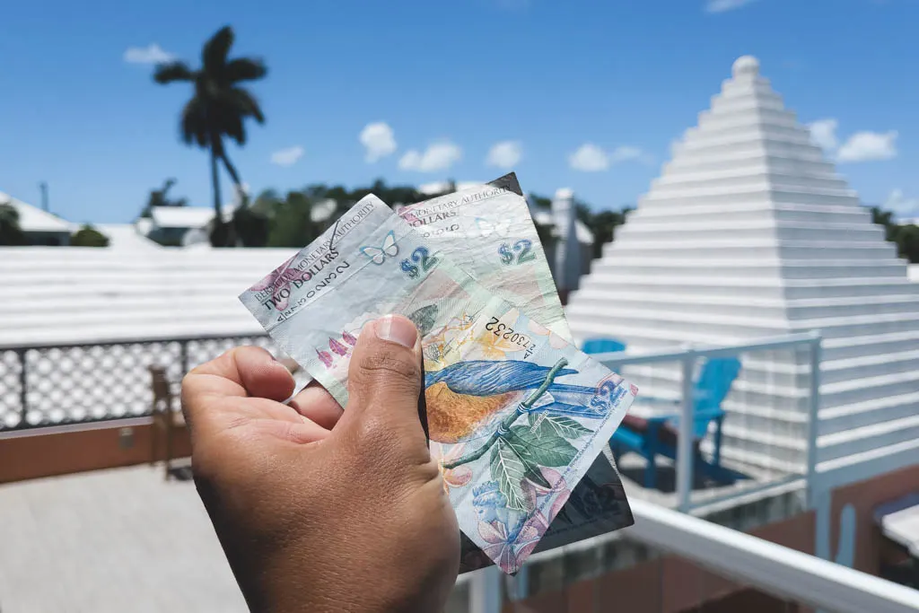 My boyfriend holding cash to represent having cash at restaurants in bermuda might come in handy at more local spots. 
