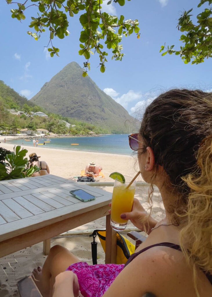 Me with a cocktail at Sugar Beach with Pitons in the distance