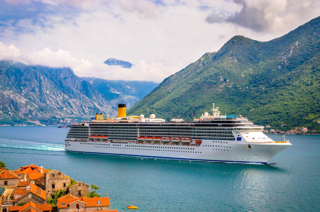 Cruise ship with mountain backdrop