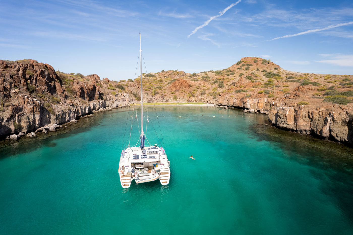 Nina swimming besides a catamaran boat in the bay of Playa Luna de Miel in Baja Sur. Nina swimming besides a catamaran boat in the bay of Playa Luna de Miel in Baja Sur.