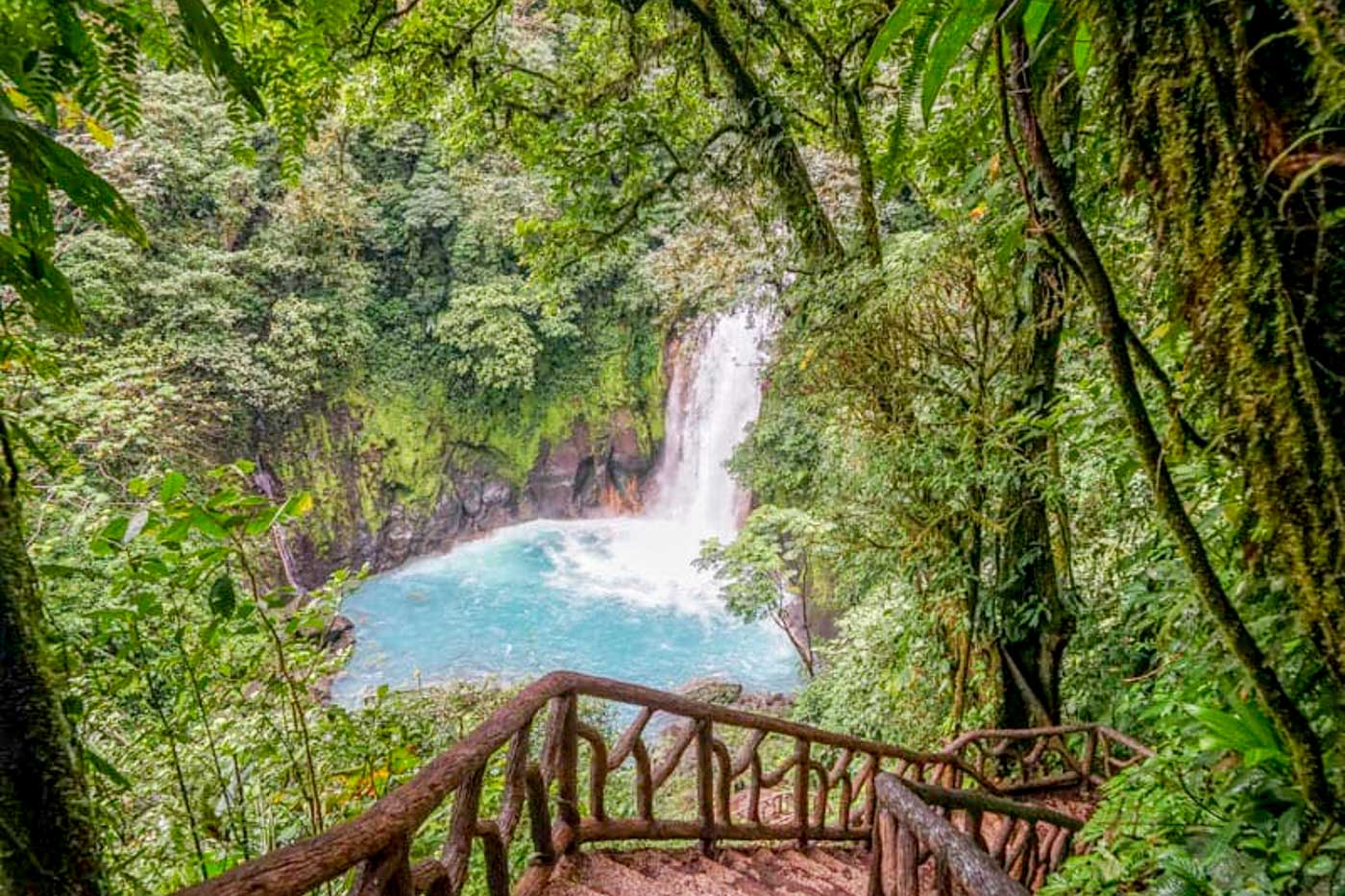 View of Rio Celeste Waterfall from the stairs in the forest.