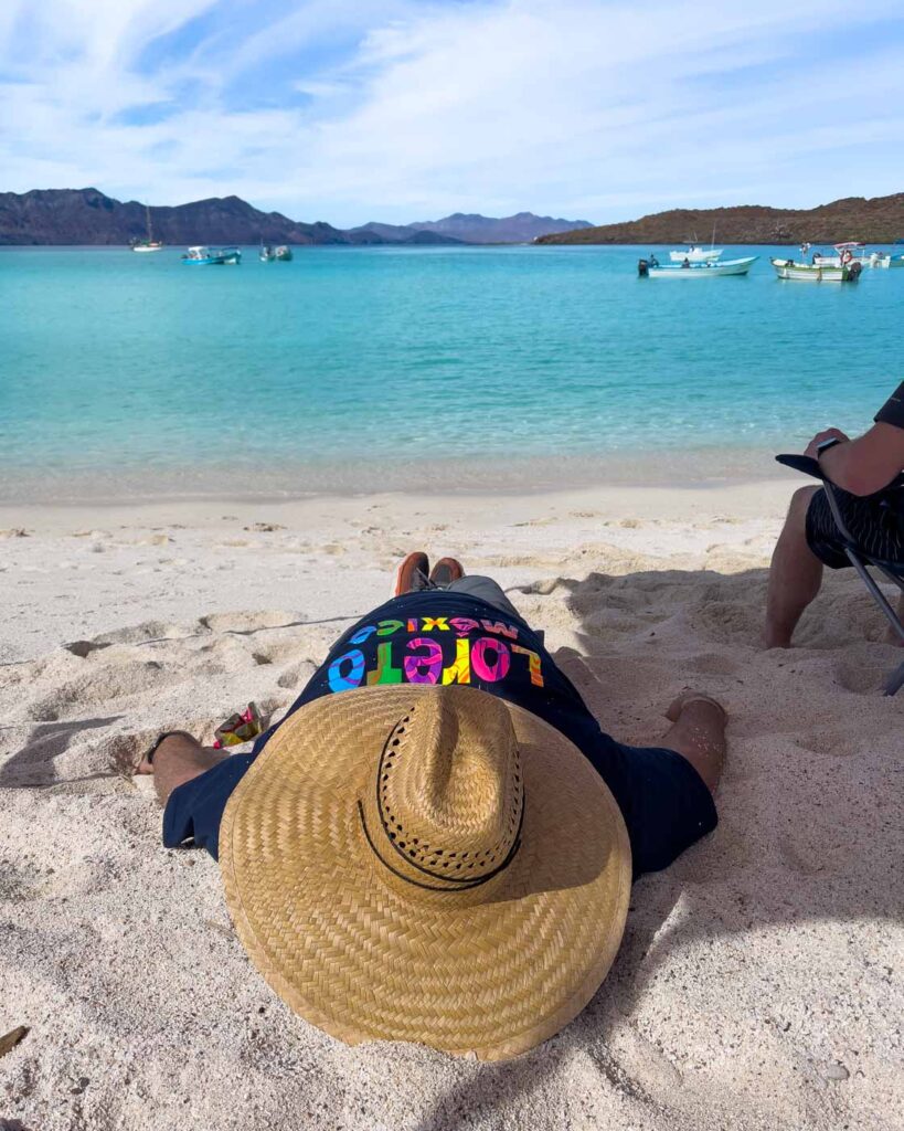 Man taking a nap on Playa Isla Coronado in Baja California Sur.
