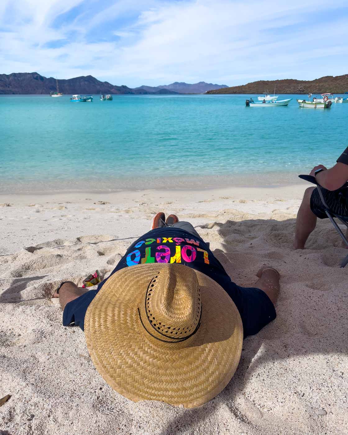 Man taking a nap on Playa Isla Coronado in Baja California Sur. Man taking a nap on Playa Isla Coronado in Baja California Sur.