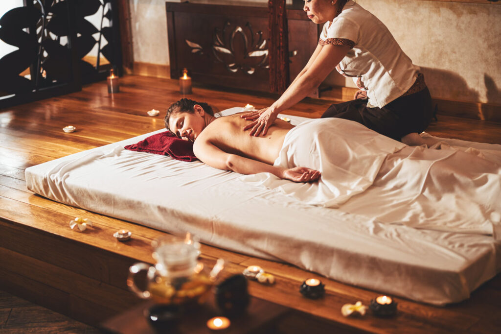 Woman laying down and enjoying a Thai massage.