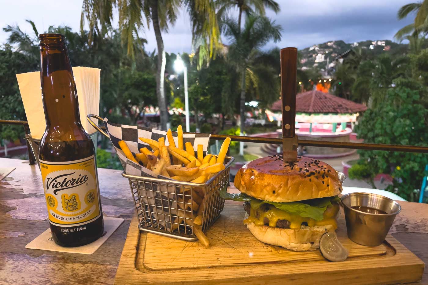Burger, fries and a beer at Public House with a view of the main plaza of Sayulita.