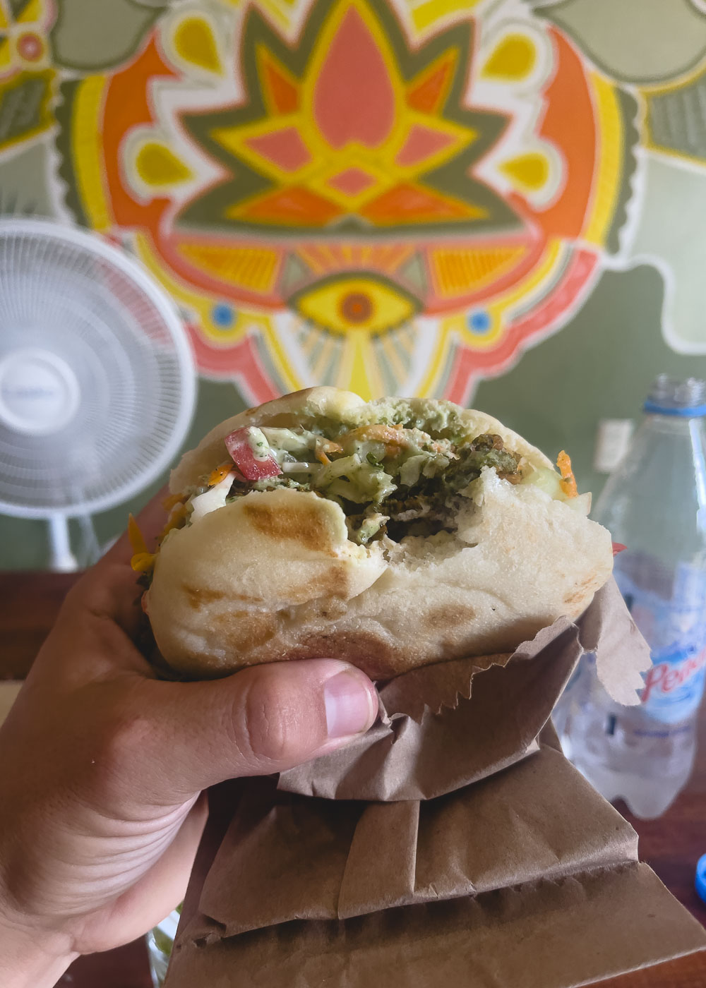 Me holding a delicious falafel sandwich at Hamsa restaurant. 