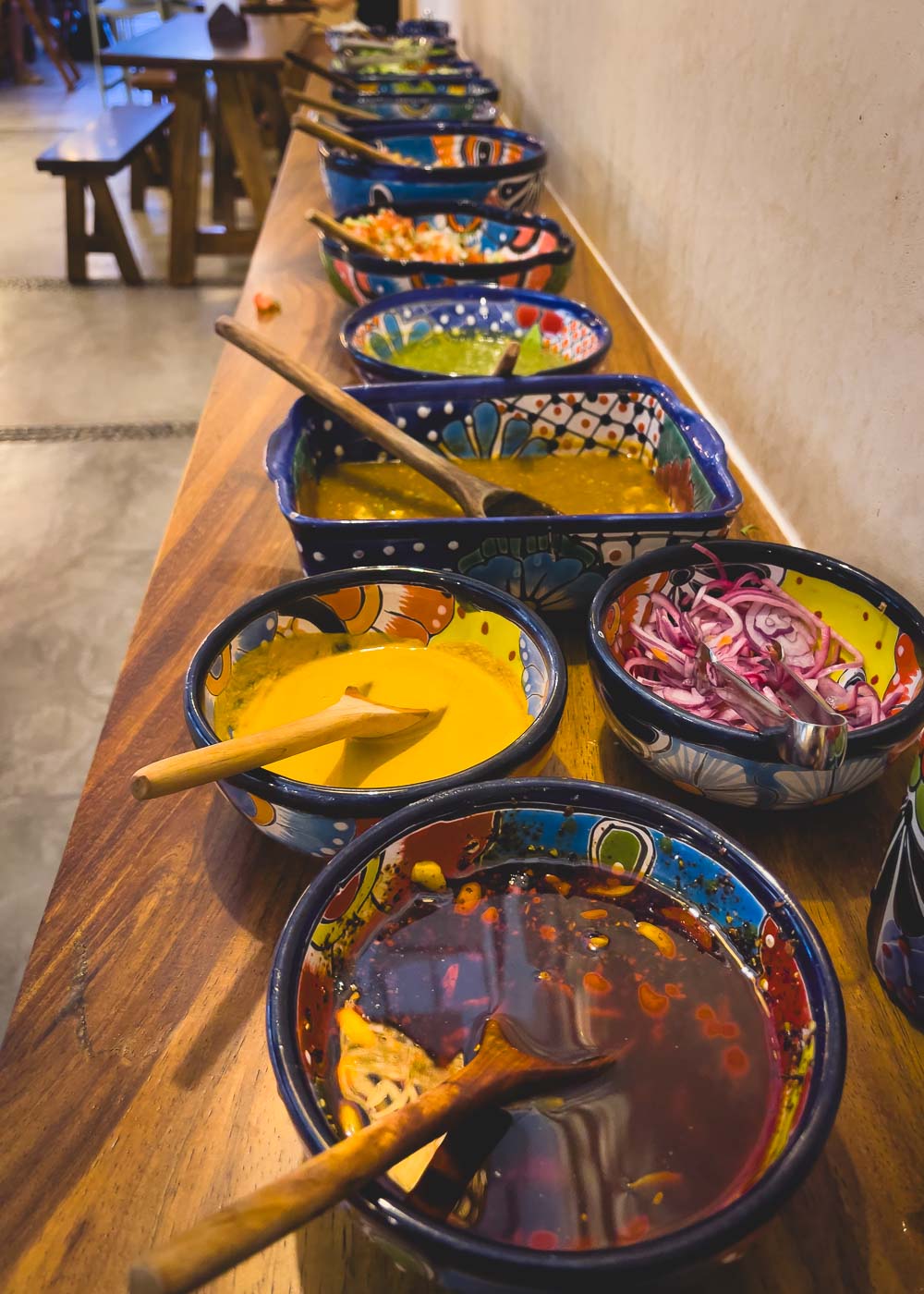 A huge bar of salsas and toppings for your tacos at Bichos restaurant. 