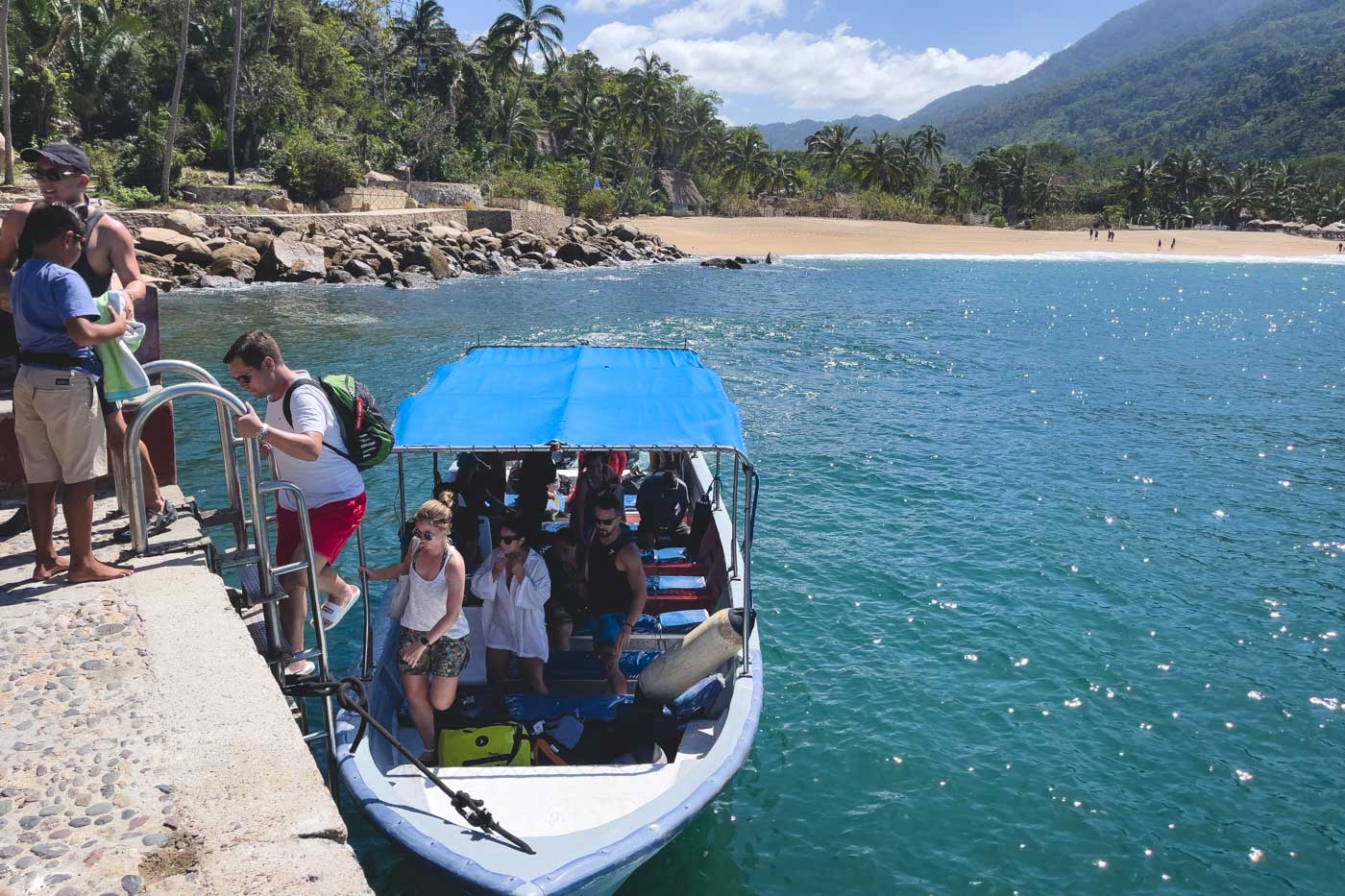 A group of people disembarking the water taxi at the pier in Yelapa.
