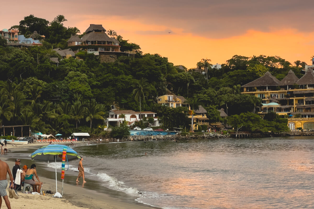 Sunset on Sayulita beach with the tropical jungle in the background.