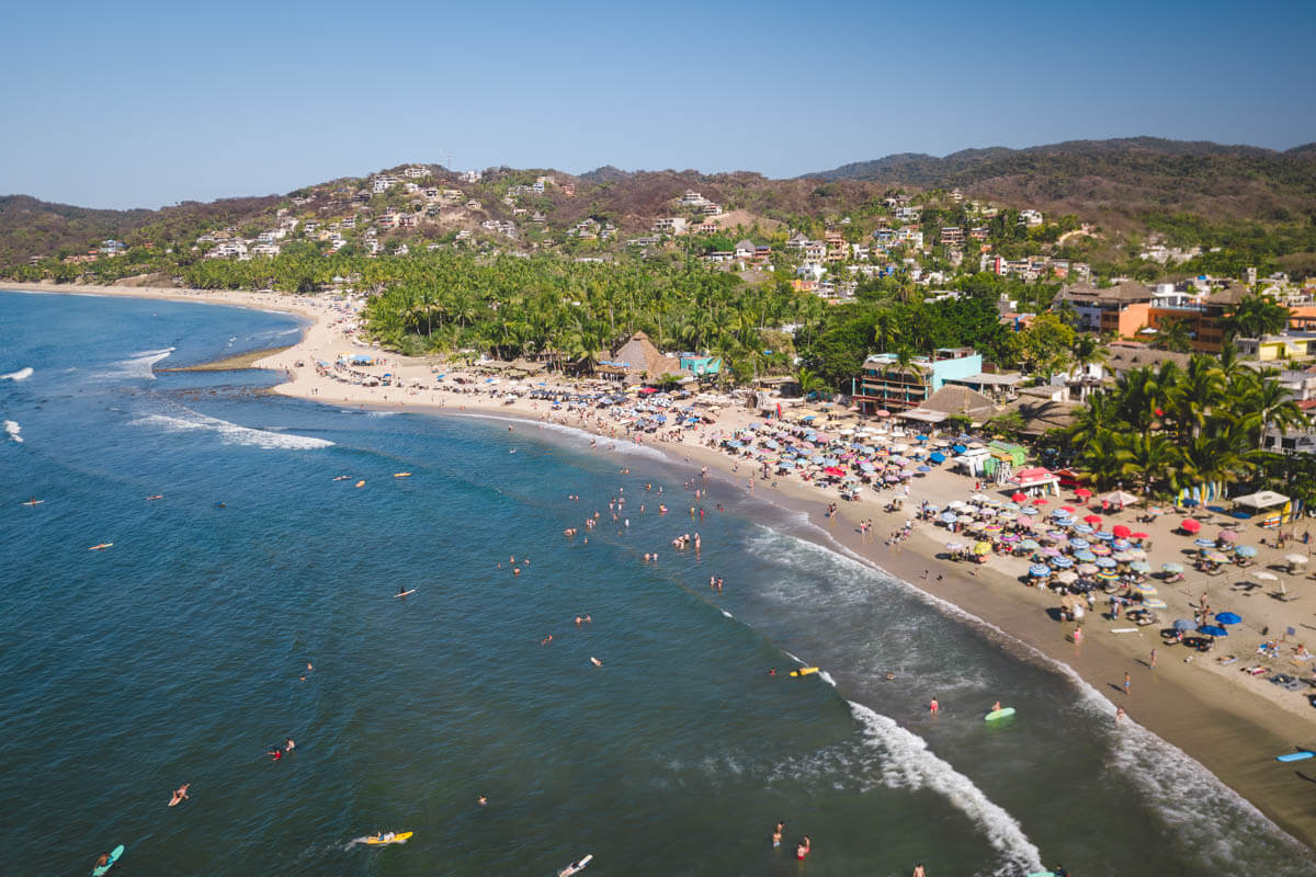 Aerial view of surfers in front of Sayulita beach.