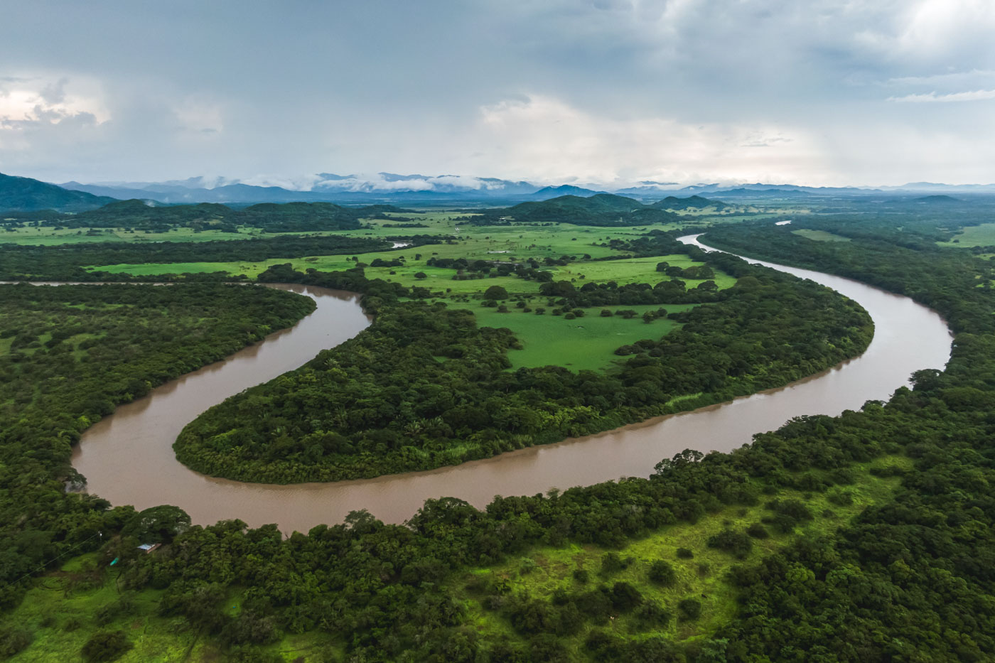 Aerial view over the winding Tempisque River running through the forests and fields of Palo Verde National Park.
