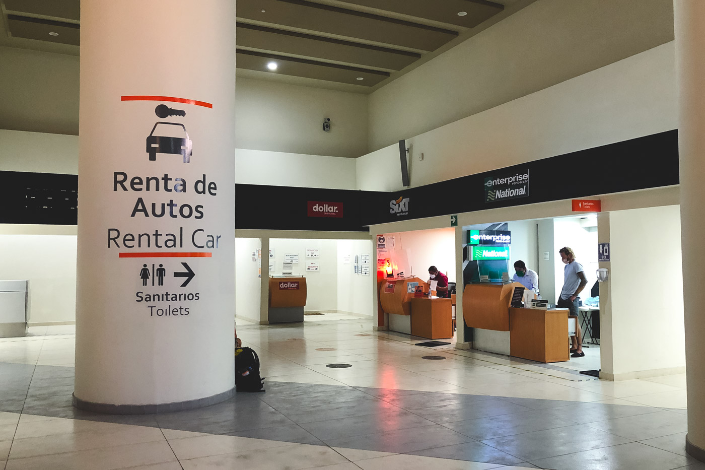 Man with a mask on renting a car from a company at San Luis Potosi airport.