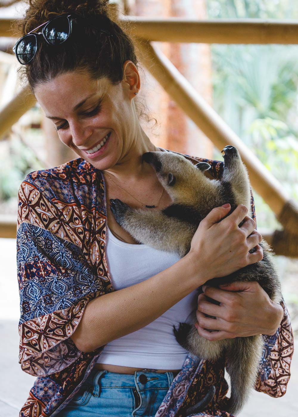 Nina smiling while cuddling a baby anteater at Selva Teenek Eco Park.