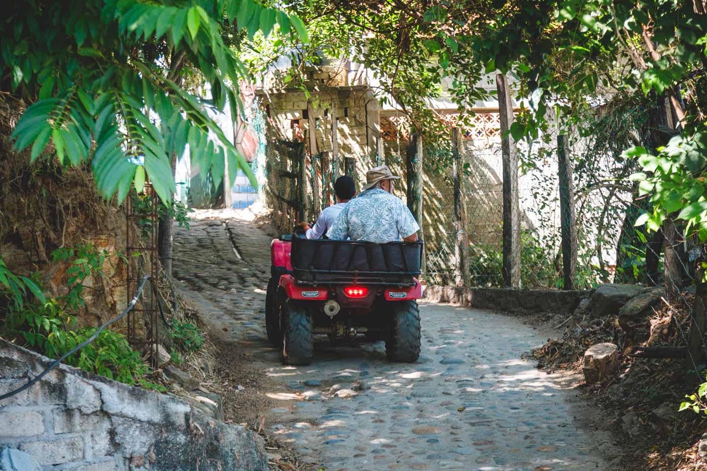 An elderly tourist being driven around on an ATV in Yelapa.