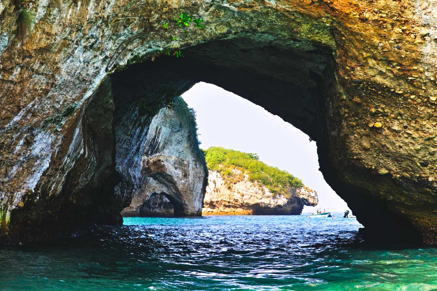 A view through Los Arcos from a snorkel boat near Puerto Vallarta on a sunny day.