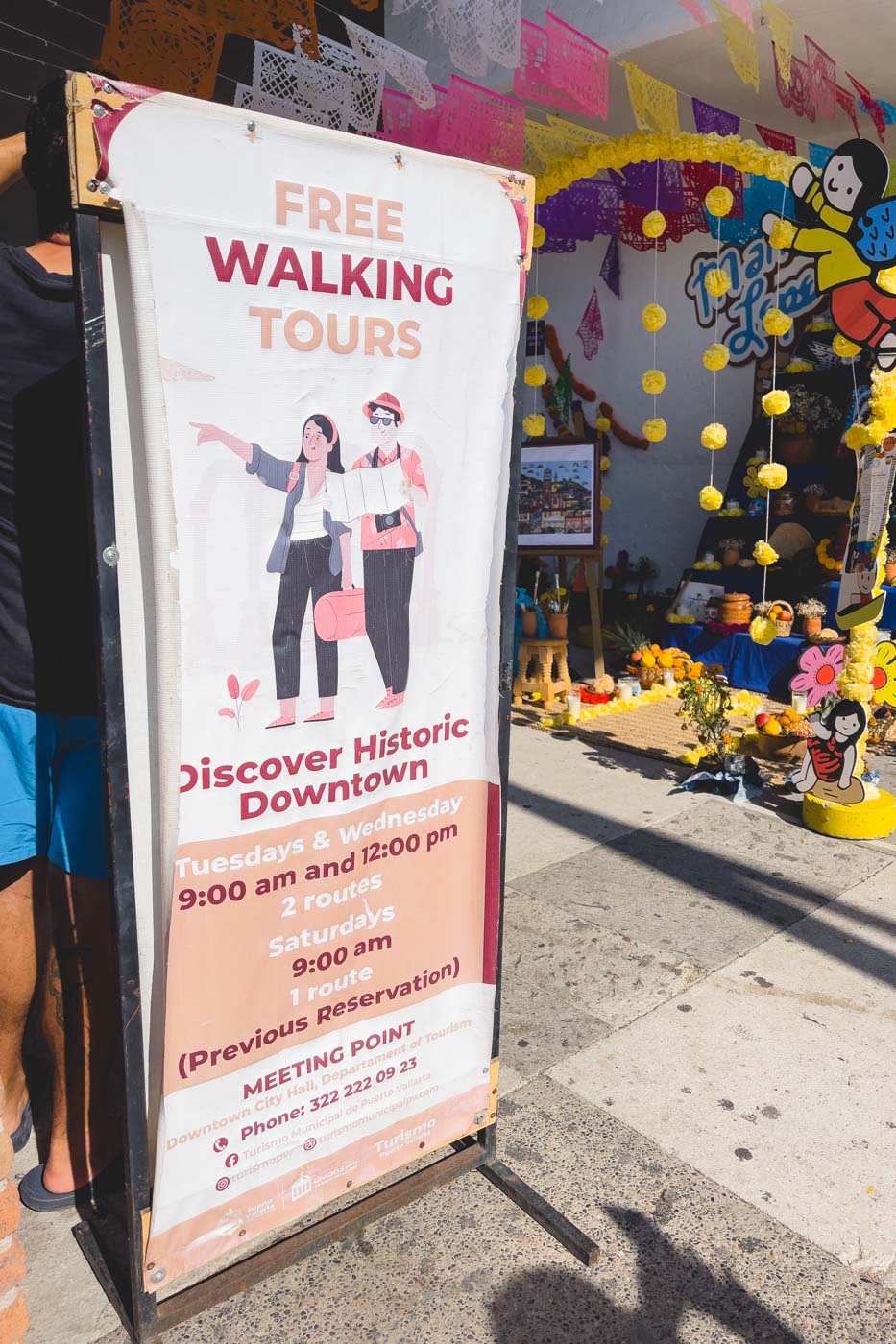 An information sign depicting free walking tours and their schedules in Puerto Vallarta.