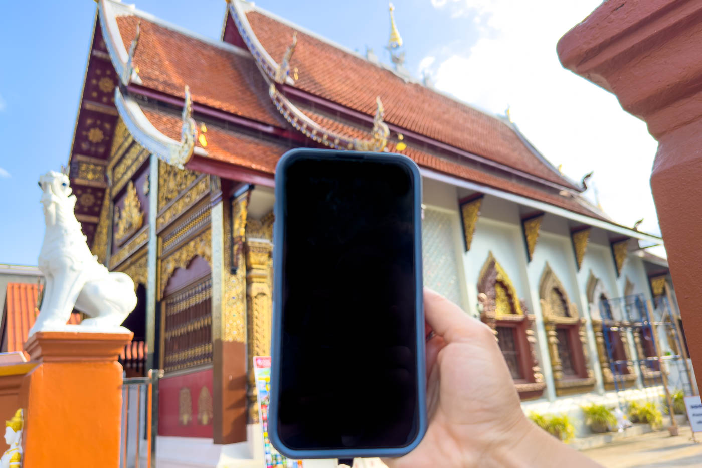 Nina's phone with a Thai temple in the back.