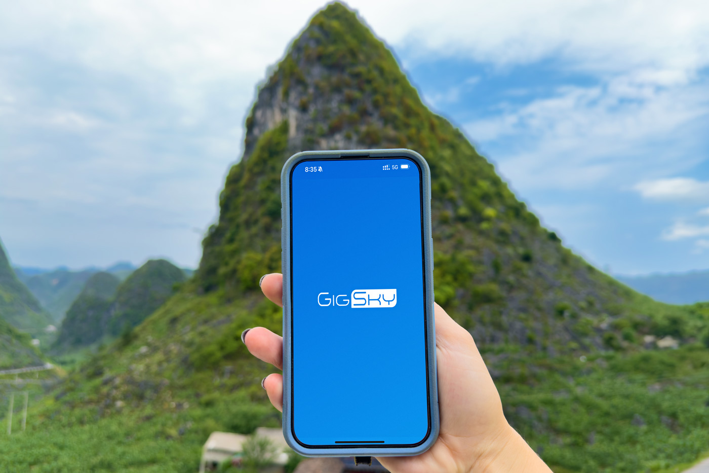 GigSky Review - a phone with GigSky on it and a mountain in the back.