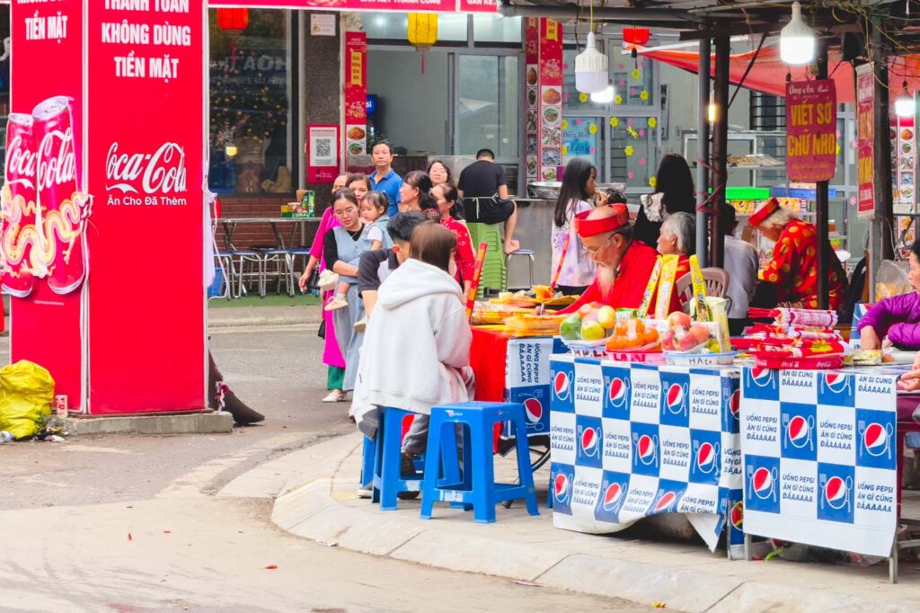 Local Vietamese sitting down at a local market in the Tay Ho area of Hanoi.