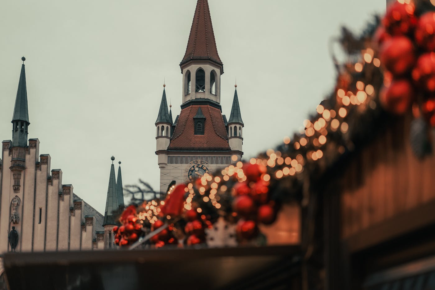 Festive Christmas market decorations with Munich architecture in the background.