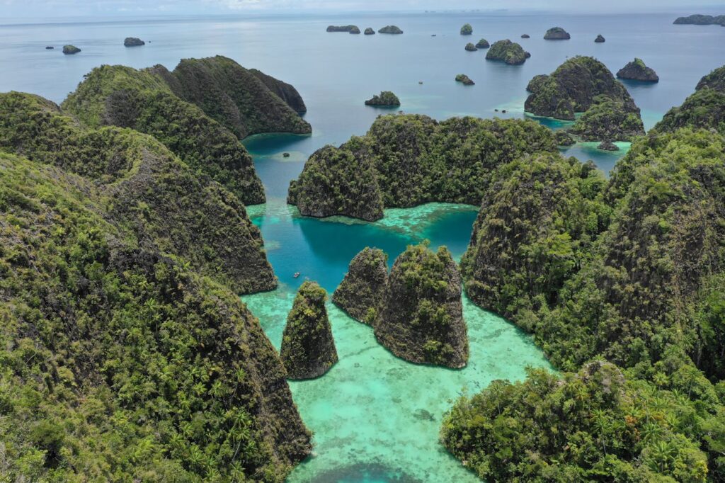 Explore the breathtaking aerial view of the lush Raja Ampat islands, a paradise in Indonesia.