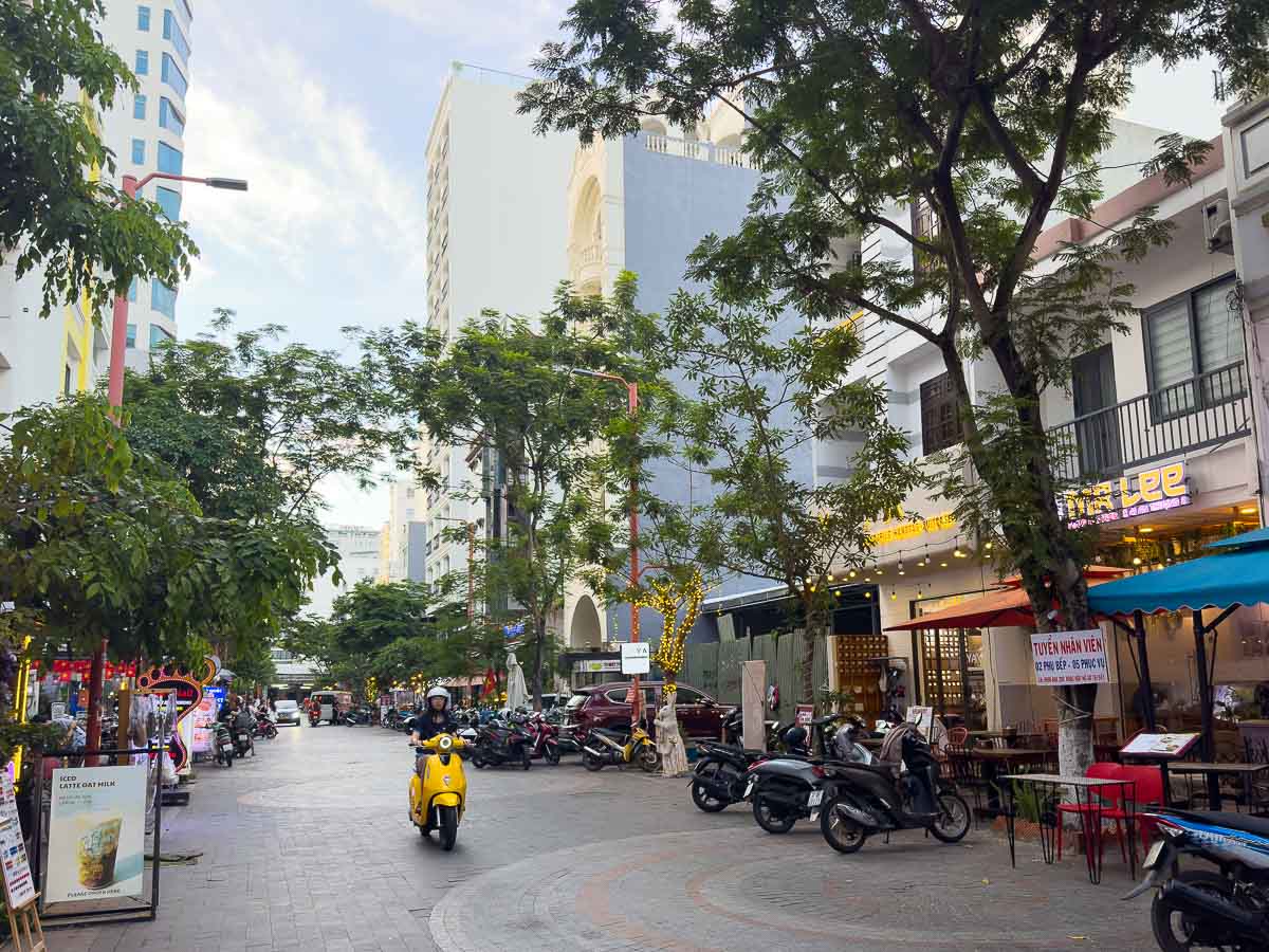 Tourist street with moto driving down.