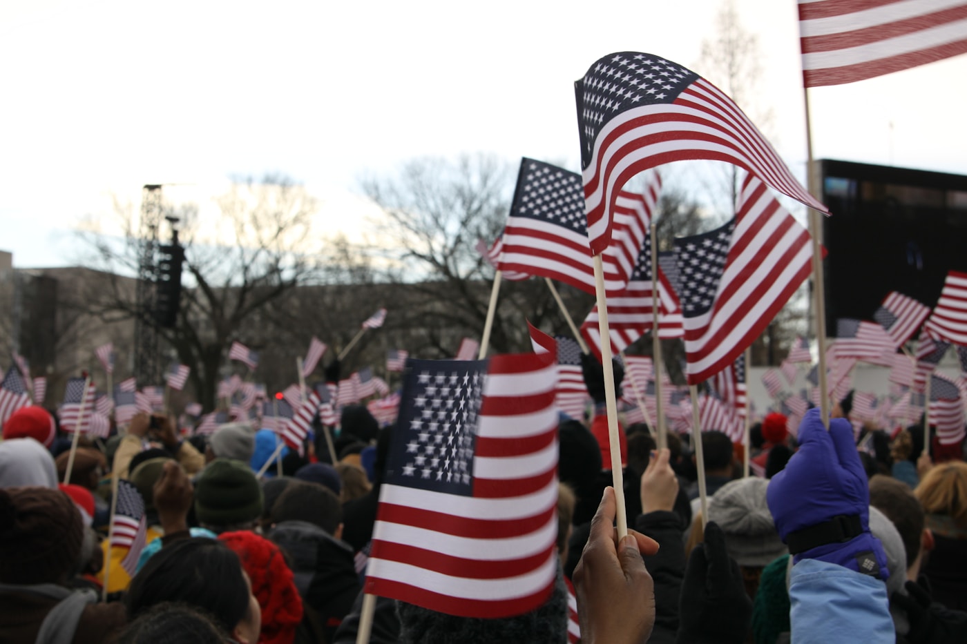 people holding us a flag during daytime